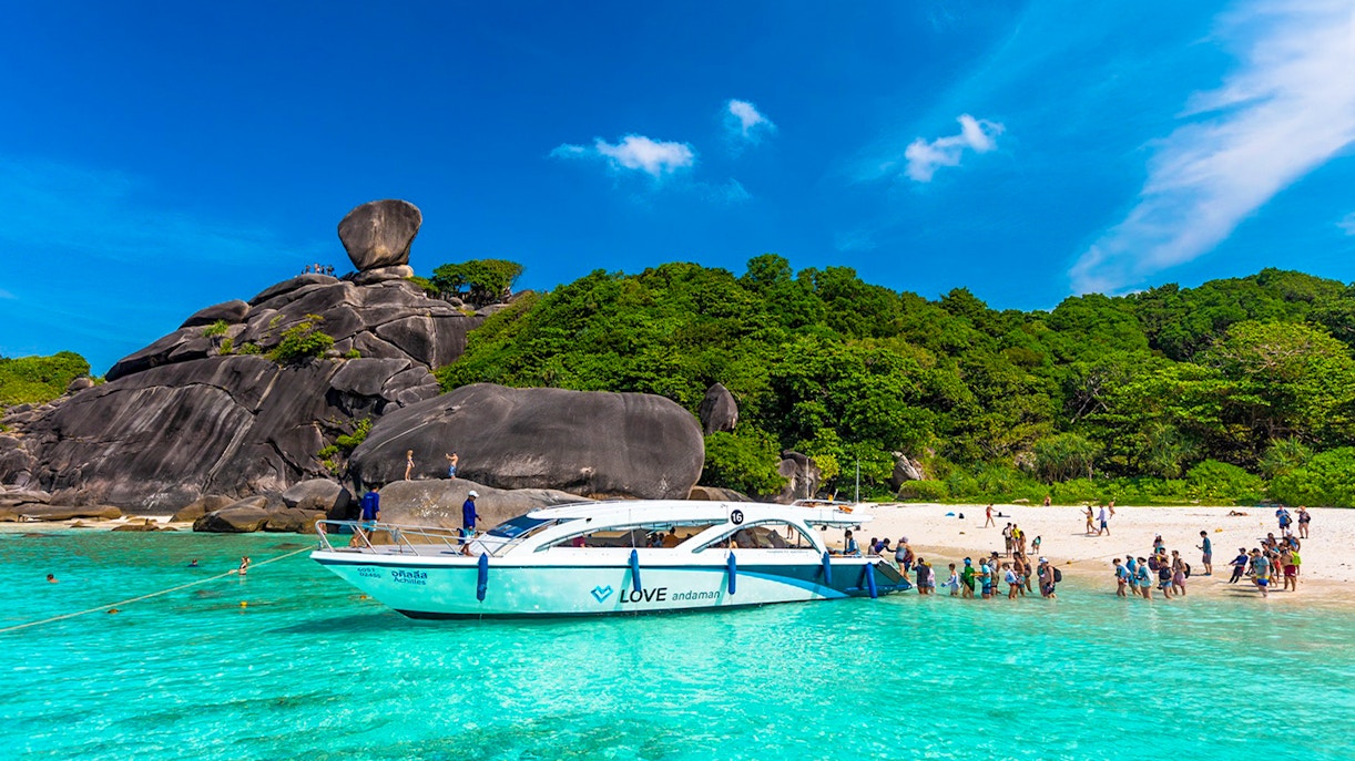 Speedboat at Similan Islands beach with tourists, Love Andaman tour.
