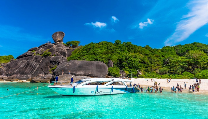 Speedboat at Similan Islands beach with tourists, Love Andaman tour.