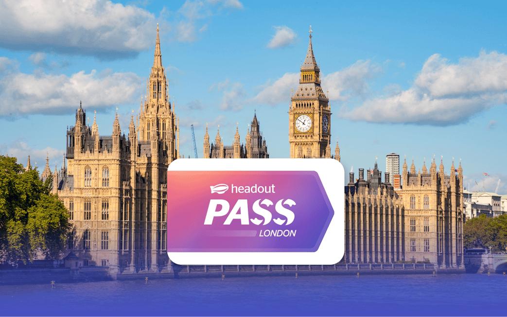 Houses of Parliament and Big Ben by the River Thames in London with Headout Pass logo.