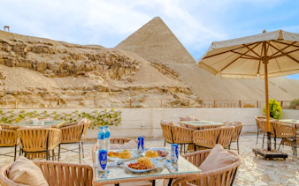 Dinner setup at Villa Khufu with view of the Great Pyramid in Giza, Egypt.