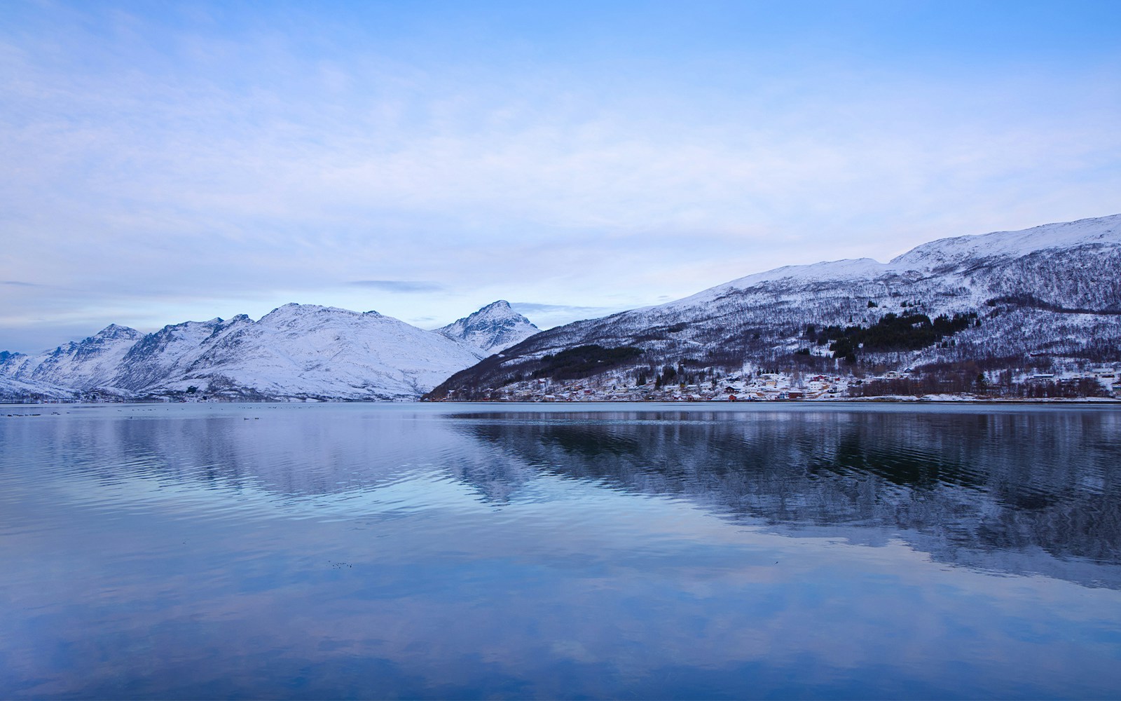 Kaldfjorden view with snow-covered mountains near Tromso, Norway.