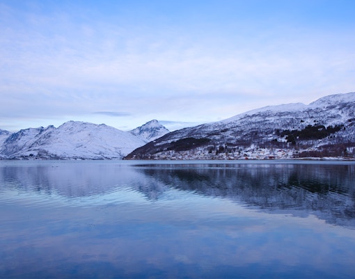 Kaldfjorden view with snow-covered mountains near Tromso, Norway.