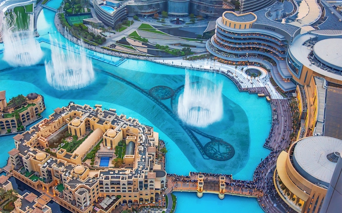 Dubai Mall fountain show with surrounding architecture and crowds.