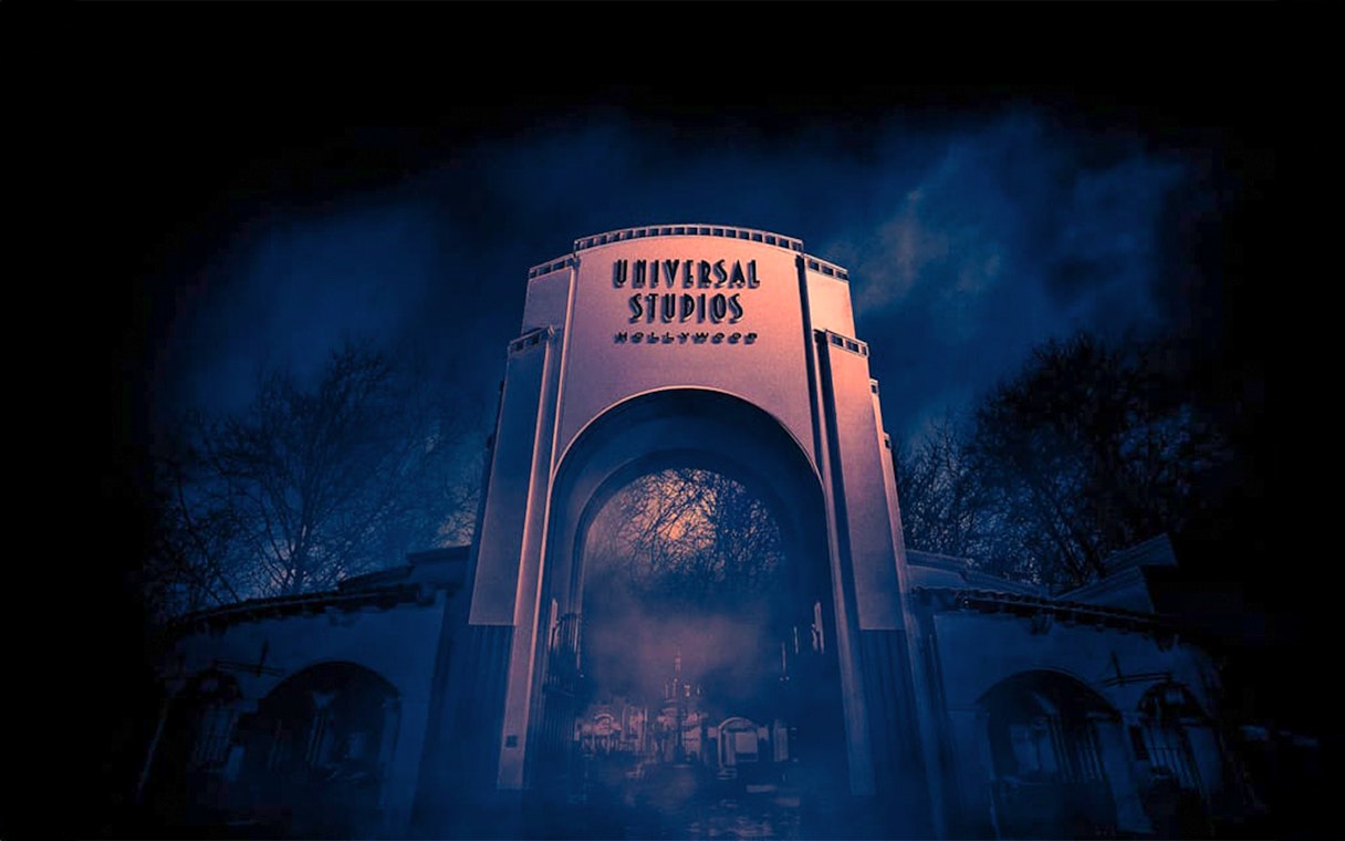 Universal Studios Hollywood entrance at night with eerie fog.