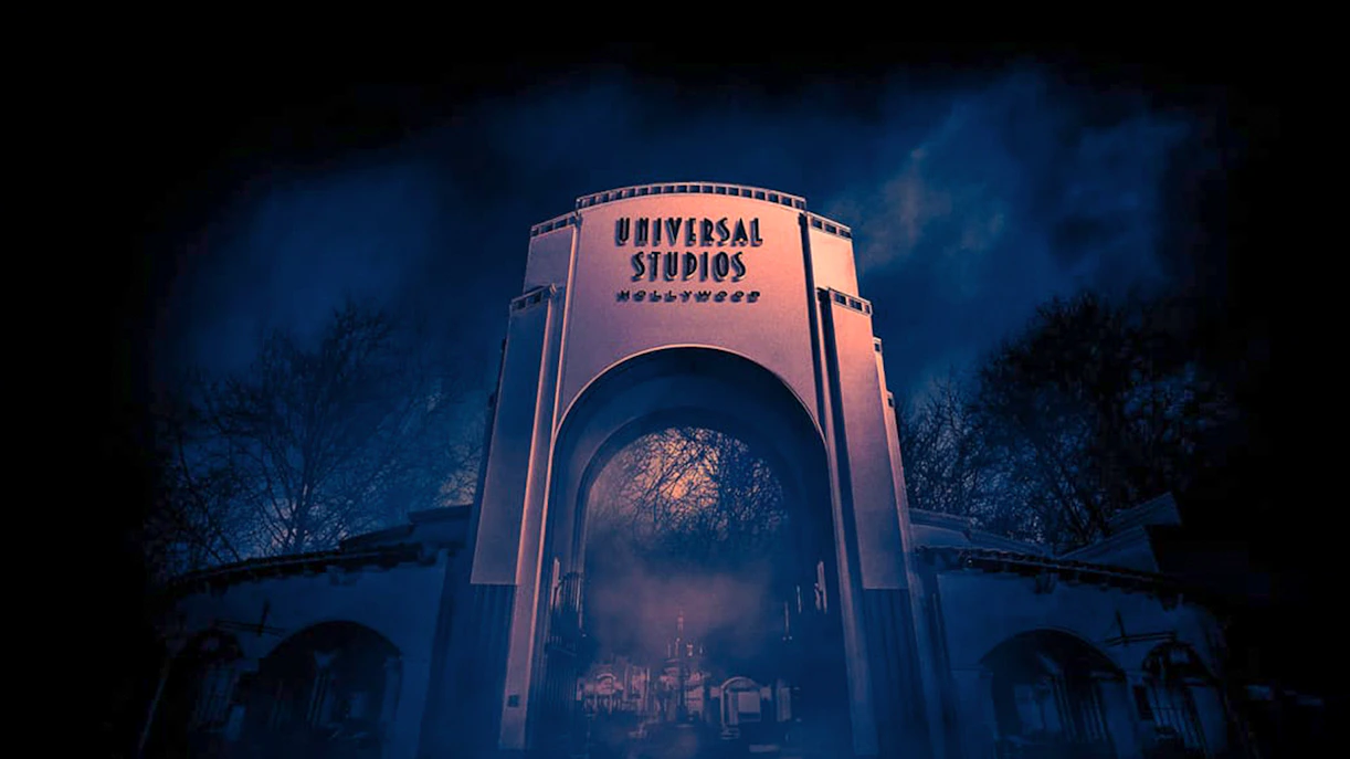 Universal Studios Hollywood entrance at night with eerie fog.