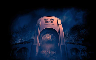 Universal Studios Hollywood entrance at night with eerie fog.