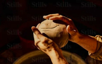 Hands shaping clay at an ancestral pottery workshop near Essaouira.