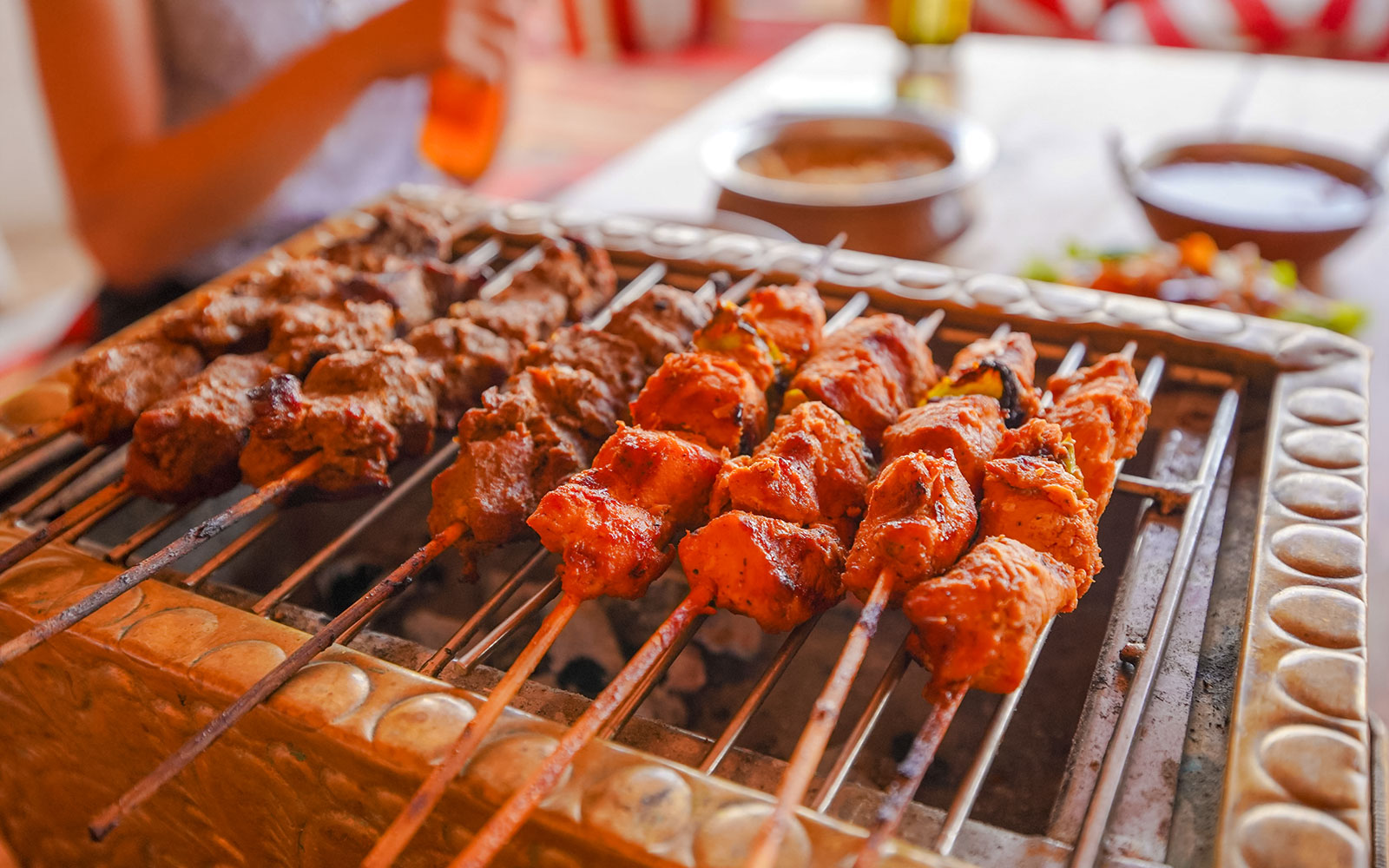 BBQ skewers on a grill during Abu Dhabi desert safari.