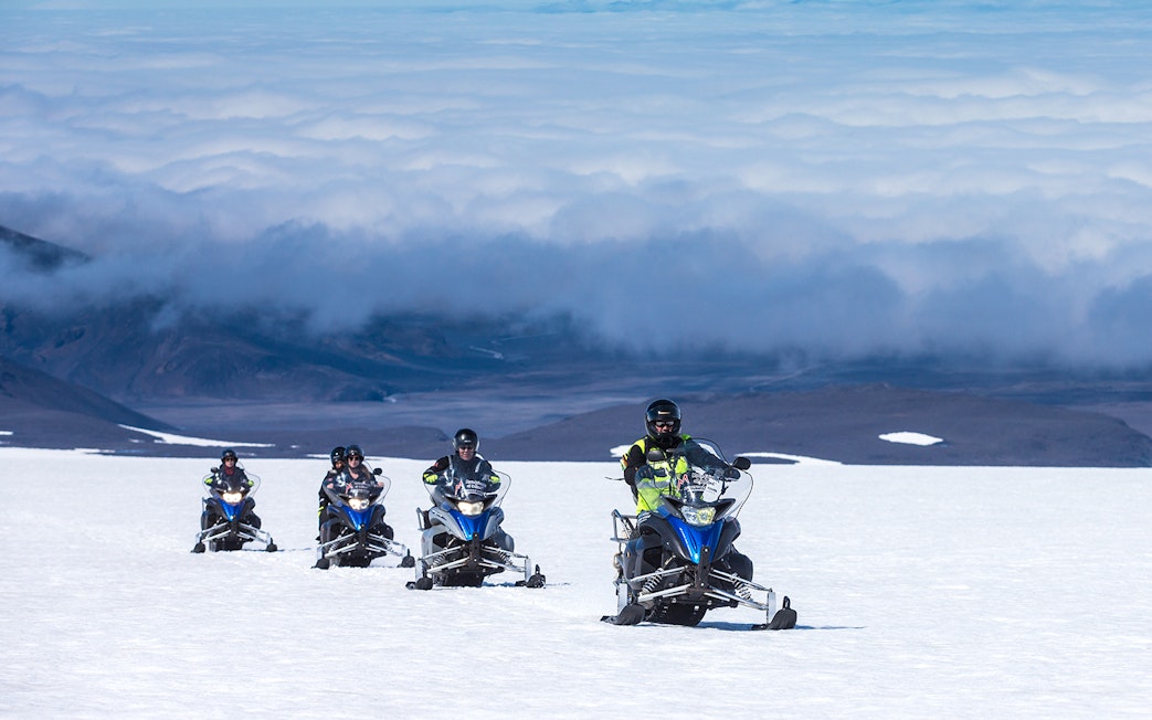 Snowmobile group riding on Langjokull Glacier, Iceland.