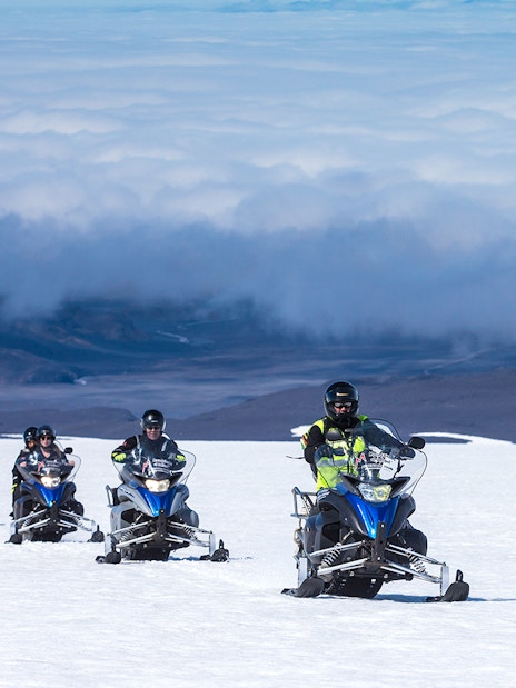 Snowmobile group riding on Langjokull Glacier, Iceland.