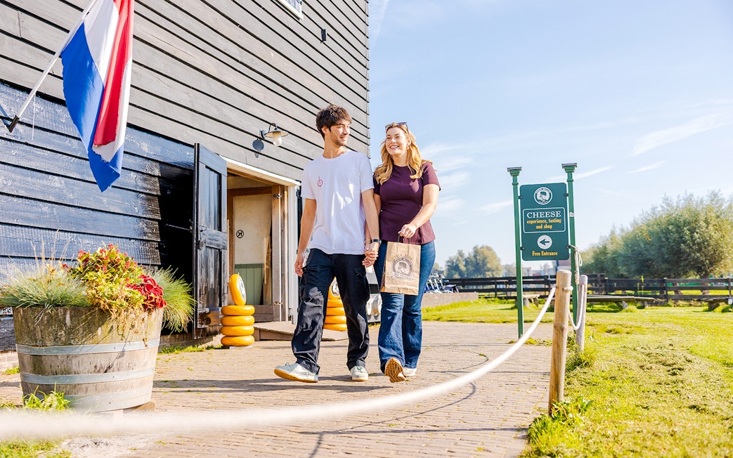 Guests walking at Zaanse Schans cheese farm entrance, Netherlands.