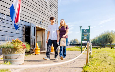 Guests walking at Zaanse Schans cheese farm entrance, Netherlands.
