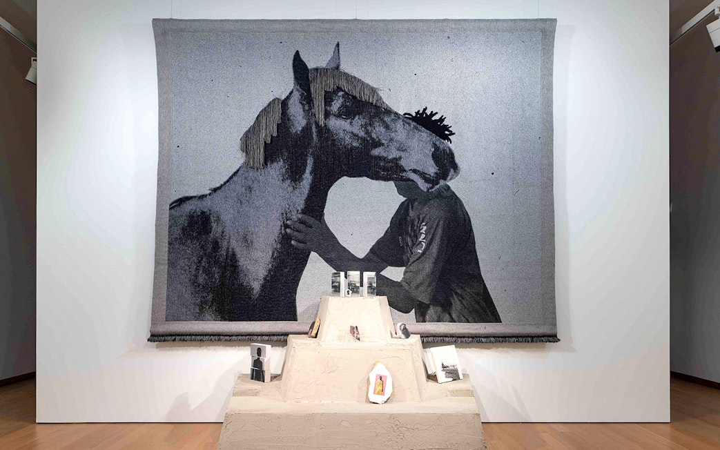 Tapestry of a person and horse at Garon et Cheval exhibit, Stedelijk Museum.