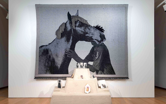 Tapestry of a person and horse at Garon et Cheval exhibit, Stedelijk Museum.