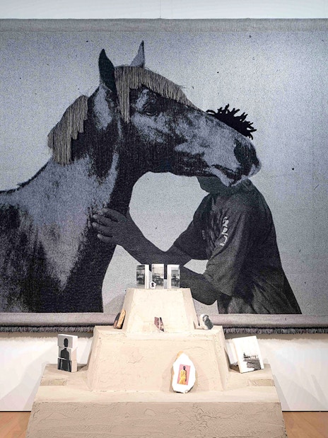 Tapestry of a person and horse at Garon et Cheval exhibit, Stedelijk Museum.