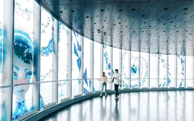 Visitors walking along the glass corridor at the Top of Shanghai Observatory, Shanghai Tower.