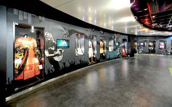 Museum exhibit with costumes and memorabilia at Stade de France, Paris.
