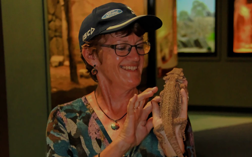 Person holding a lizard at Crocosaurus Cove, Australia.