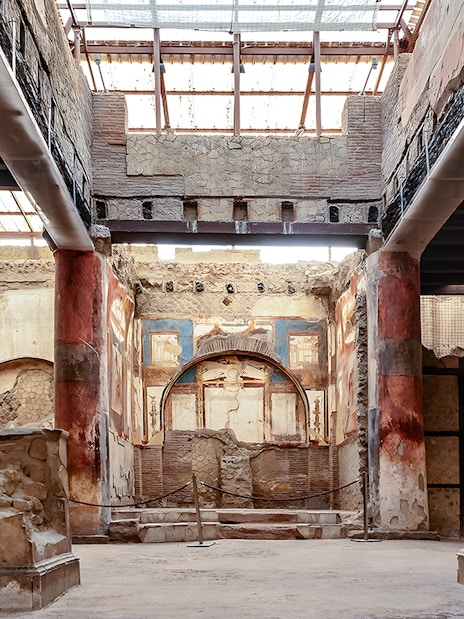 Ruins of the College of the Augustales with frescoes and columns in Herculaneum, Italy.