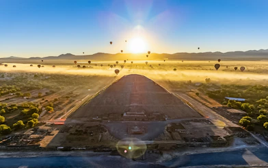 Hot air balloons over Teotihuacan Pyramid at sunrise, Mexico.