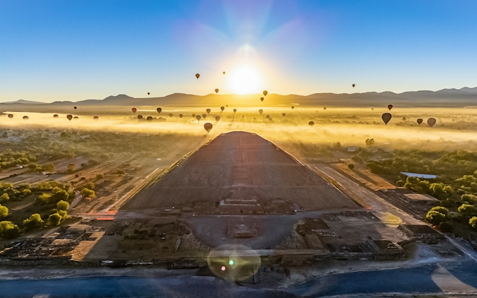 Hot air balloons over Teotihuacan Pyramid at sunrise, Mexico.