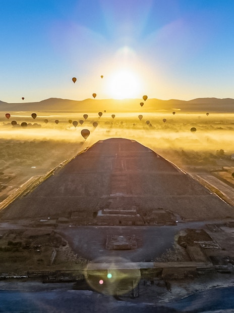Hot air balloons over Teotihuacan Pyramid at sunrise, Mexico.