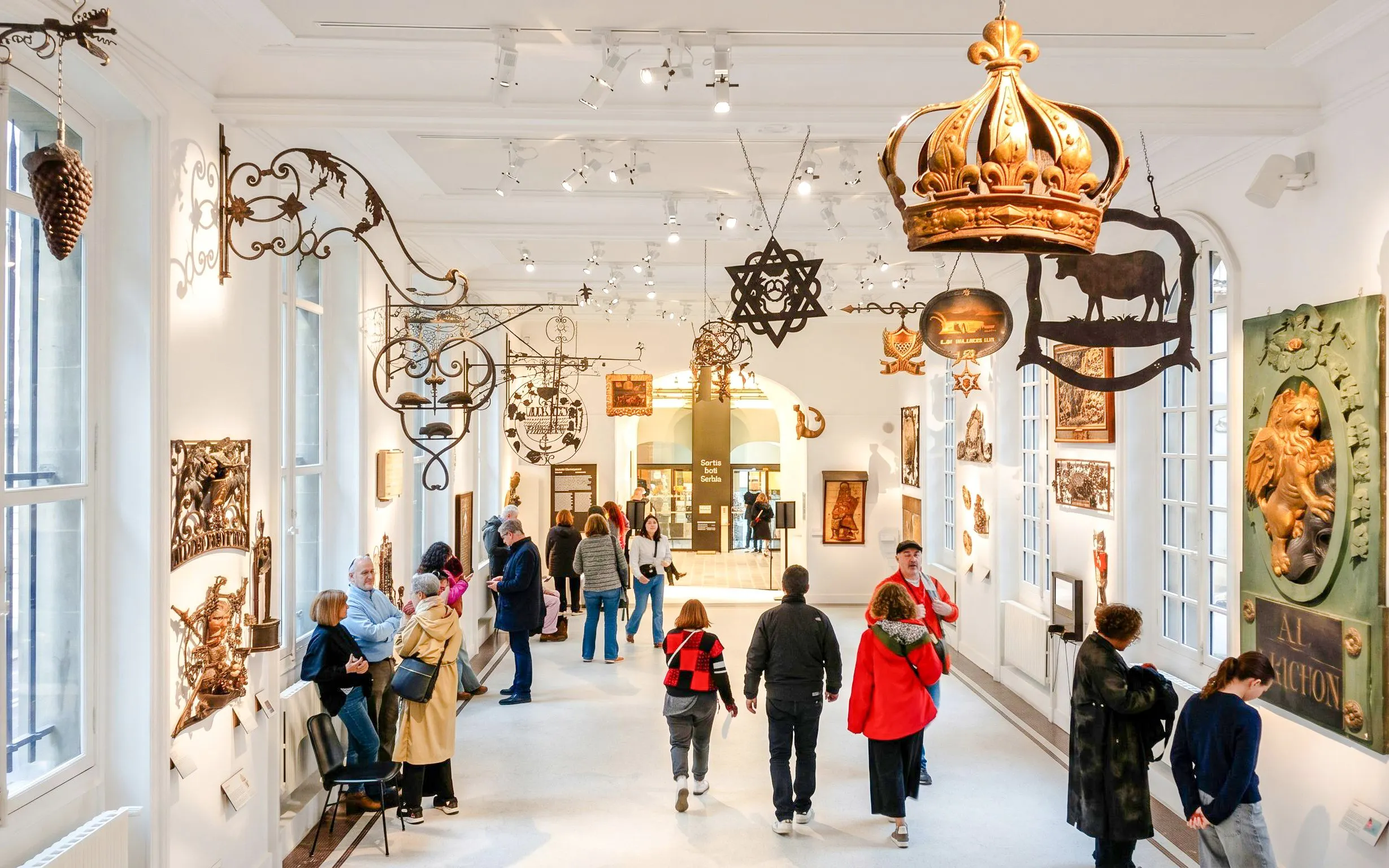 Visitors exploring exhibits in the Carnavalet Museum, Paris.