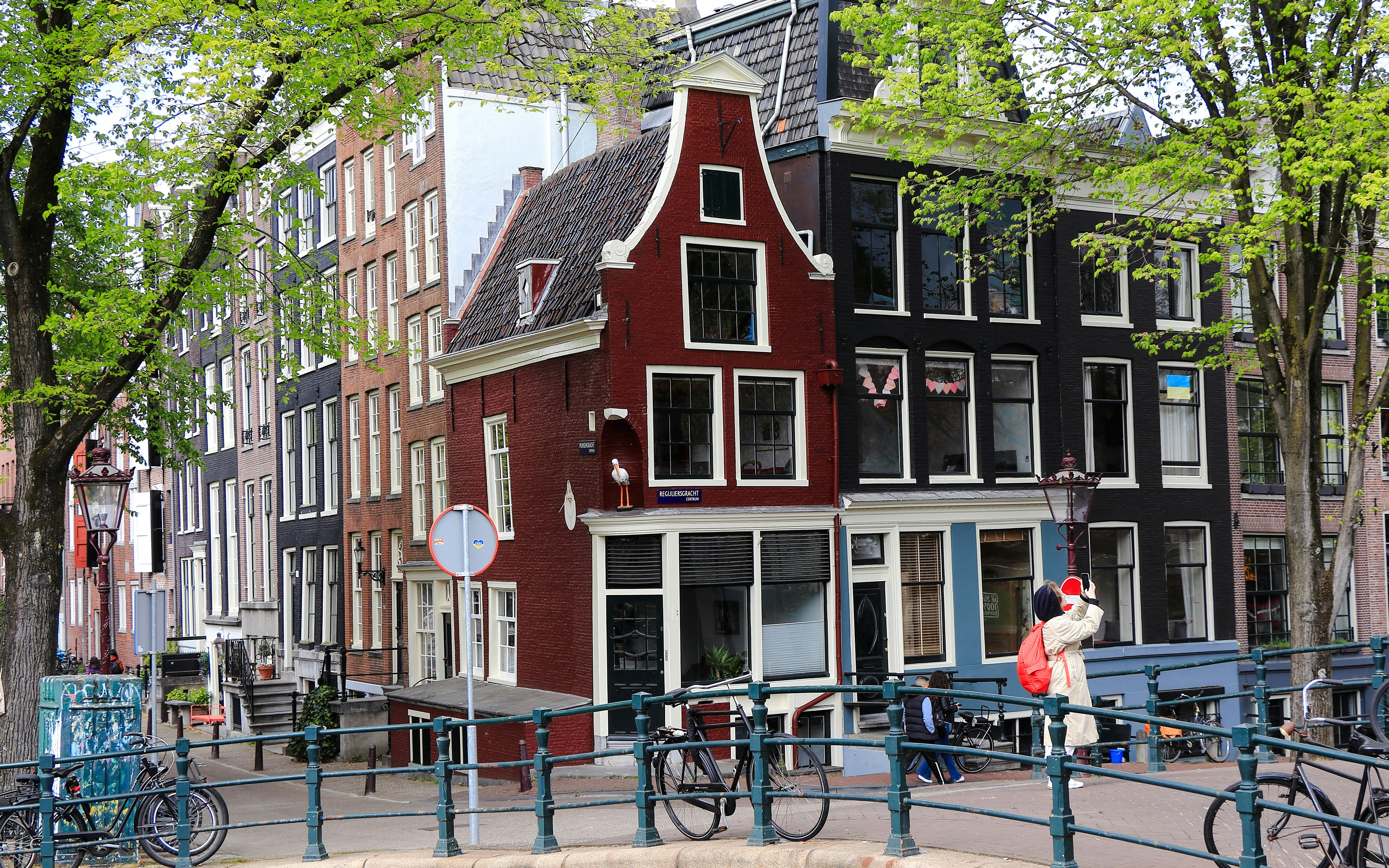 Stork House in Amsterdam with traditional Dutch architecture along a canal.