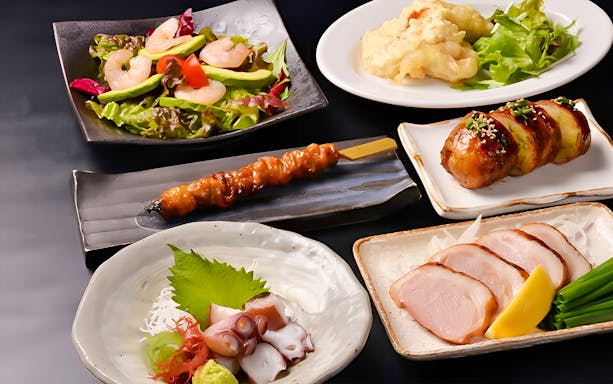 Traditional Japanese dishes including yakitori, sashimi, and salad at Hakata Dojo Ueno.