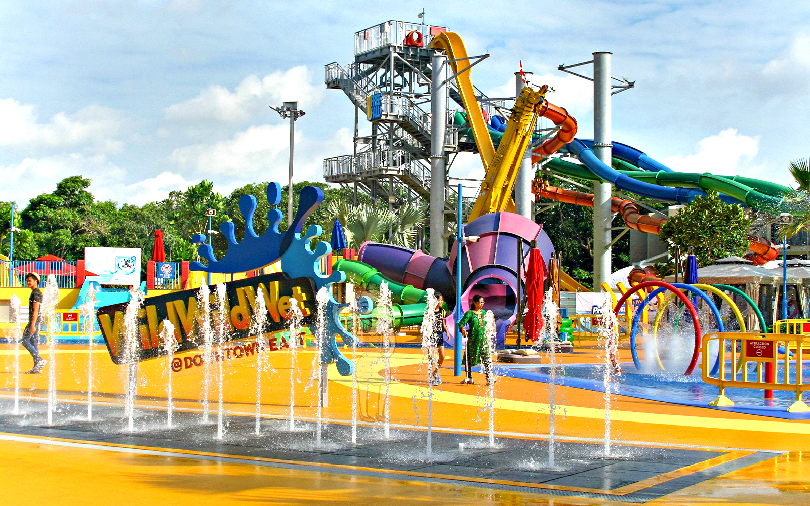 Wild Wild Wet water park entrance with colorful slides and splash fountains in Singapore.