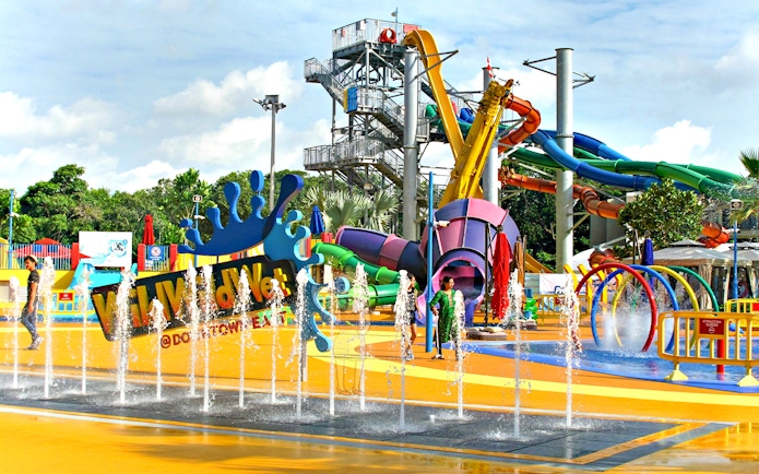 Wild Wild Wet water park entrance with colorful slides and splash fountains in Singapore.