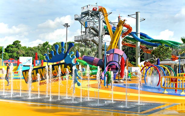 Wild Wild Wet water park entrance with colorful slides and splash fountains in Singapore.