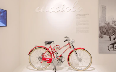 Vintage Ducati Cucciolo motorbike display at Ducati Museum, Bologna.