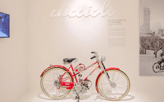 Vintage Ducati Cucciolo motorbike display at Ducati Museum, Bologna.