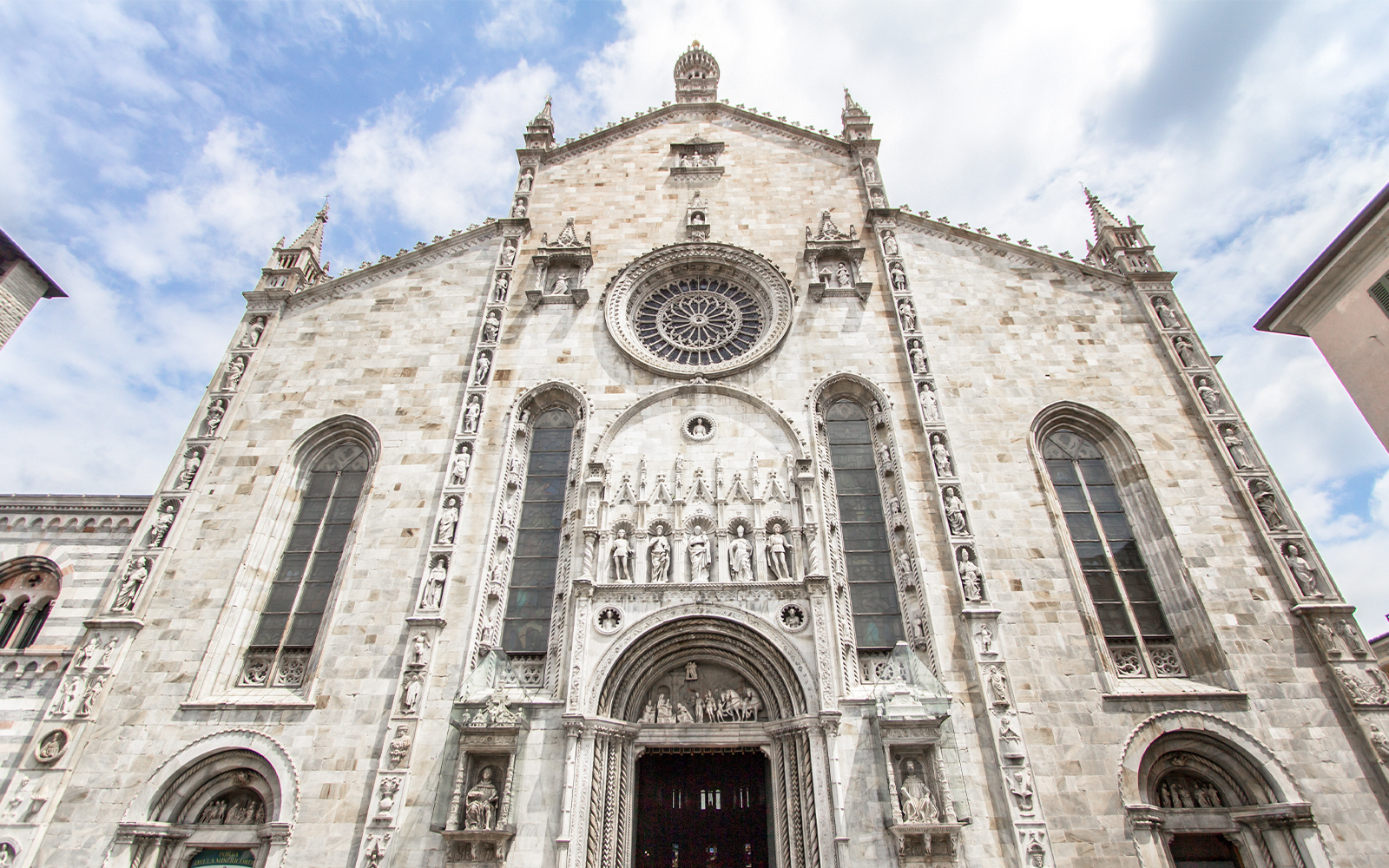 Como Cathedral facade with intricate sculptures, Italy.