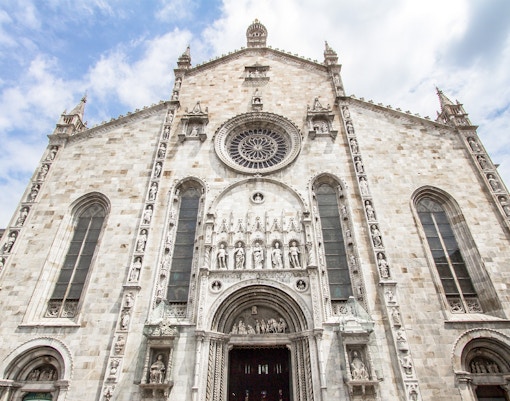 Como Cathedral facade with intricate sculptures, Italy.