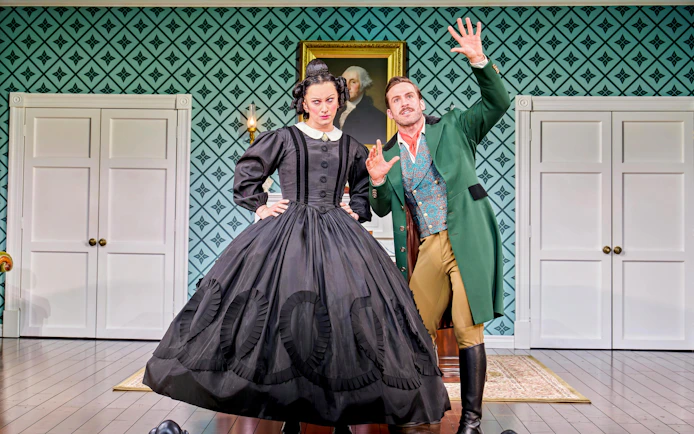 Actors in period costumes performing a scene from "Oh Mary!" in a vintage room setting.