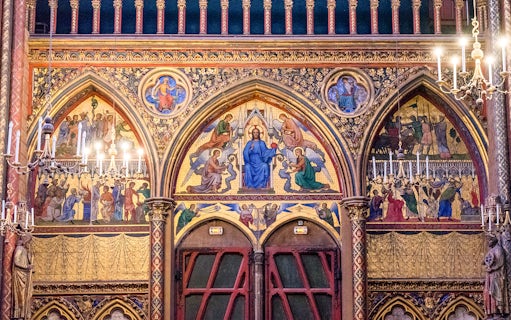Paintings depicting religious scenes on the wall of Sainte-Chapelle, Paris.
