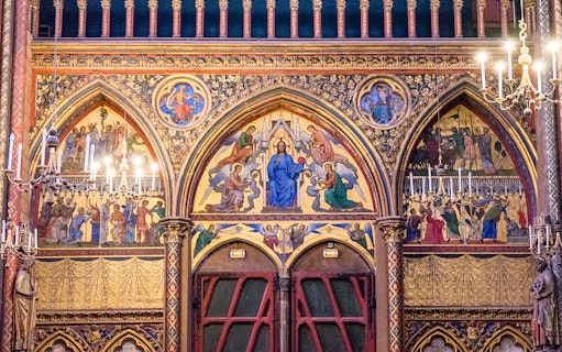 Paintings depicting religious scenes on the wall of Sainte-Chapelle, Paris.