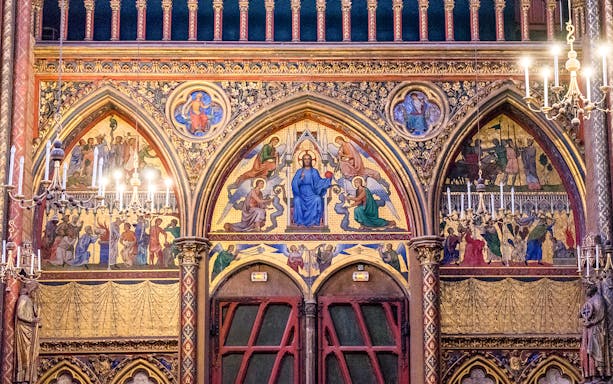 Paintings depicting religious scenes on the wall of Sainte-Chapelle, Paris.