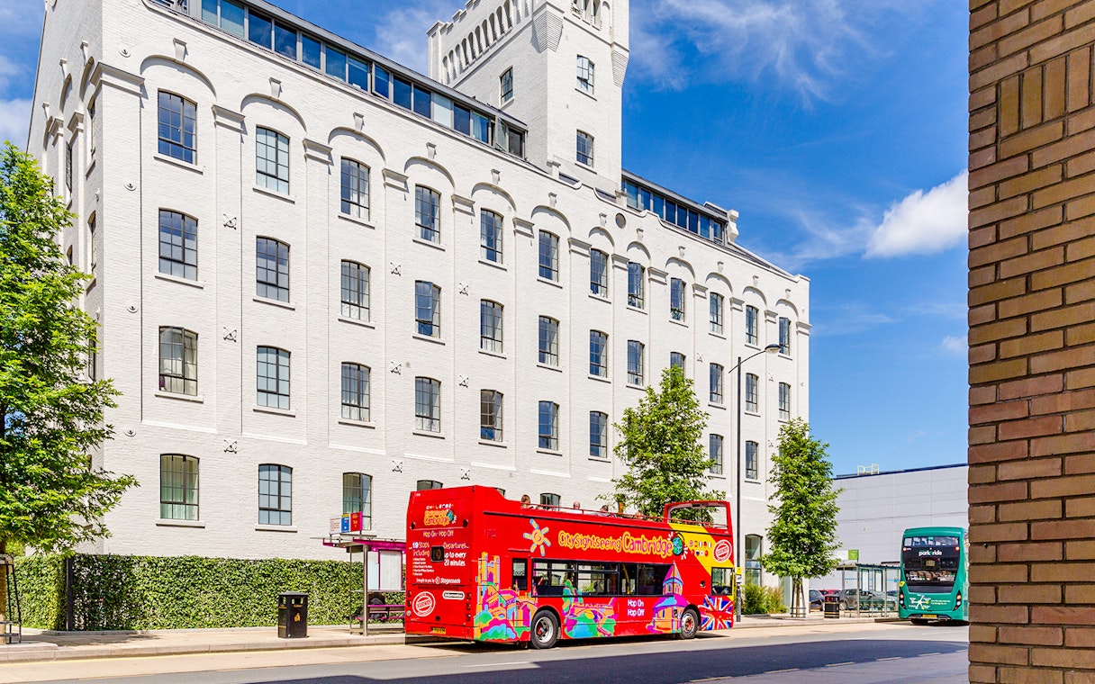 Double-decker bus on Cambridge Hop-On Hop-Off Tour passing Spillers Mill.