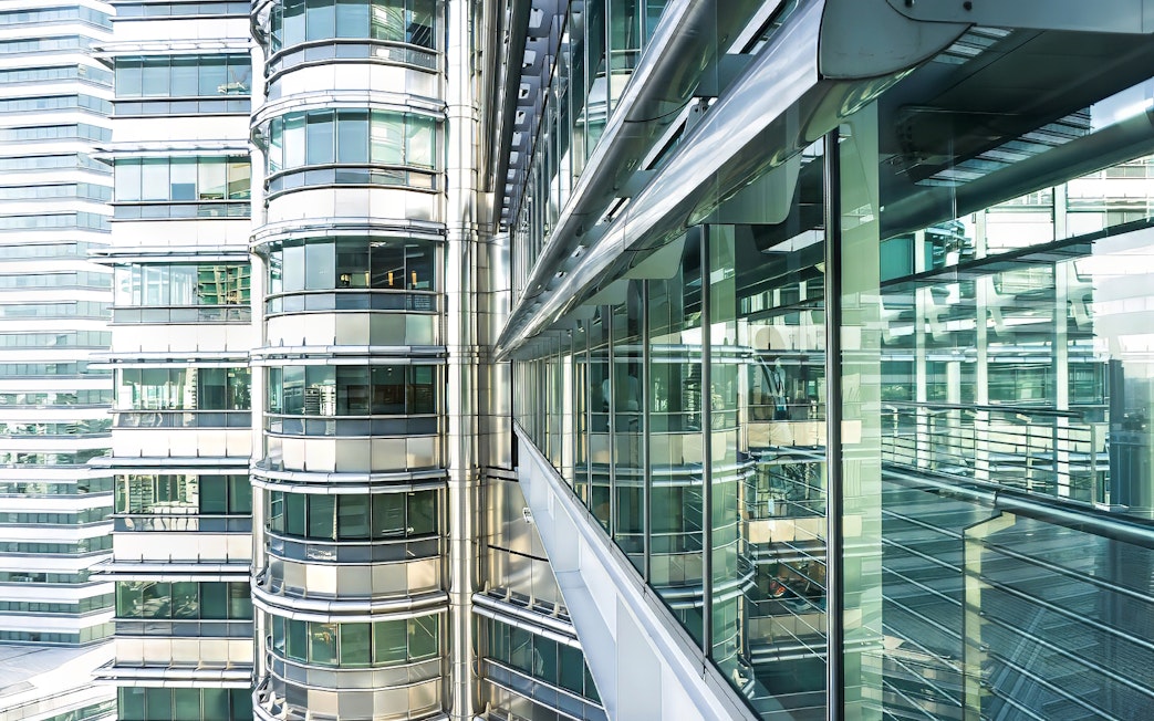 Skybridge exterior of Petronas Twin Towers, Kuala Lumpur, with glass and steel architecture.