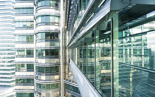 Skybridge exterior of Petronas Twin Towers, Kuala Lumpur, with glass and steel architecture.