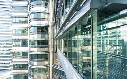 Skybridge exterior of Petronas Twin Towers, Kuala Lumpur, with glass and steel architecture.
