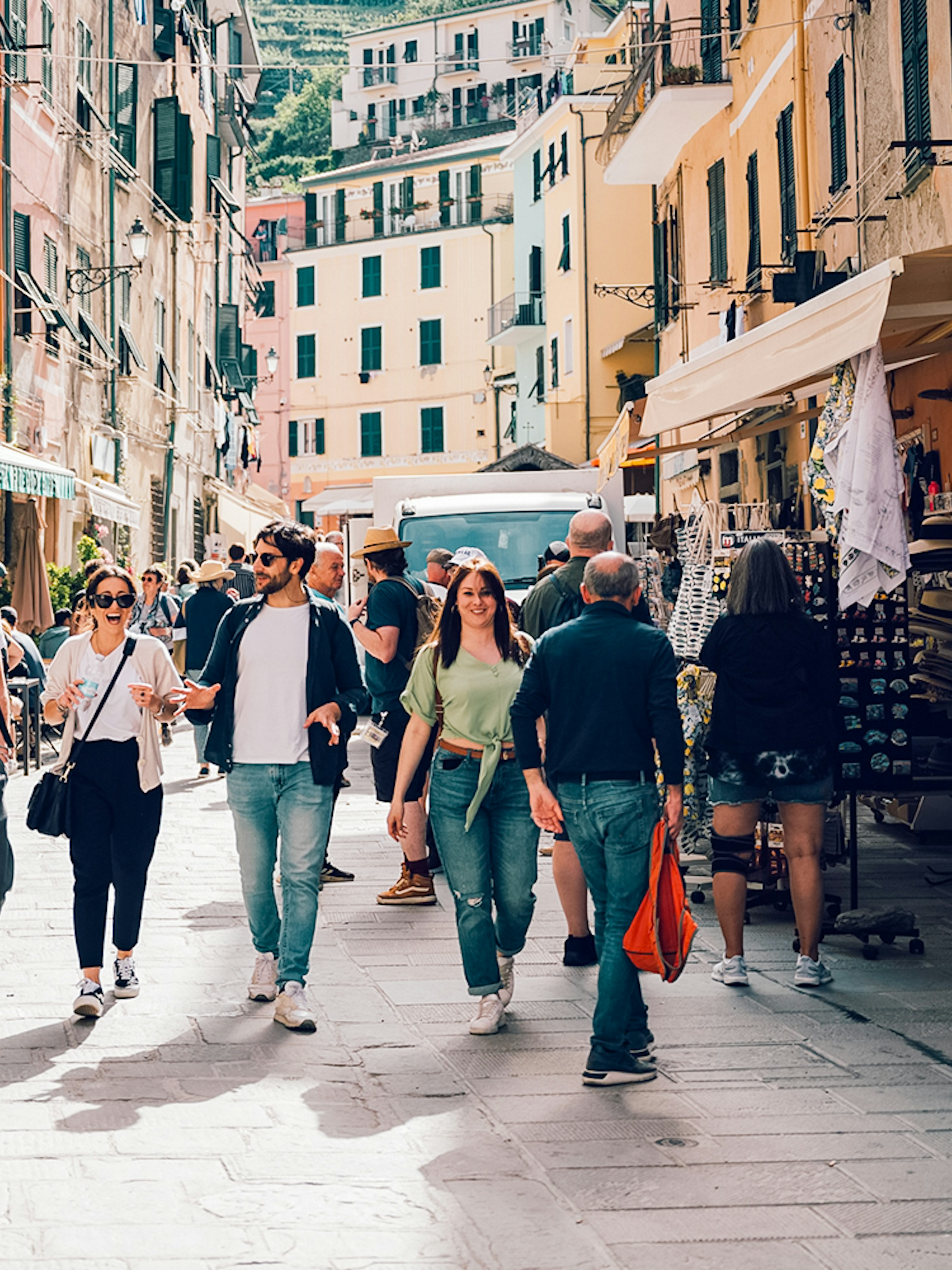 Participants exploring a vibrant street in Cinque Terre during a day trip from Florence.