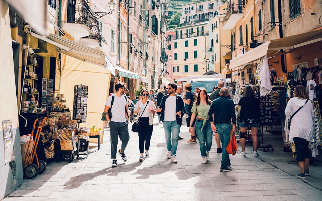 Participants exploring a vibrant street in Cinque Terre during a day trip from Florence.