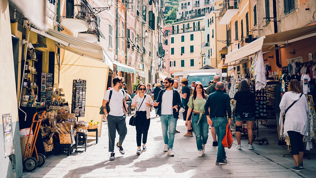 Participants exploring a vibrant street in Cinque Terre during a day trip from Florence.