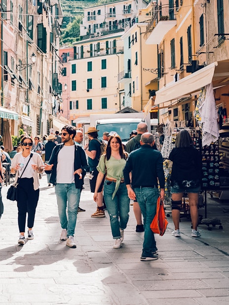 Participants exploring a vibrant street in Cinque Terre during a day trip from Florence.