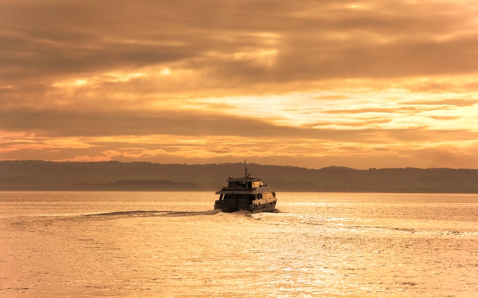 Cruise boat on water during sunset at Phillip Island.
