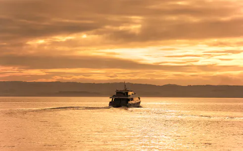 Cruise boat on water during sunset at Phillip Island.